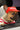 French bulldog in red cap with name "Mavik", looking out of a car